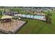 View of community playground and pool featuring clubhouse with sunshade at 118 Green Branch Blvd, Groveland, FL 34736