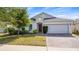 Charming single-story home with a well-manicured lawn and a brick-paved driveway at 118 Green Branch Blvd, Groveland, FL 34736