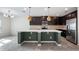 Spacious kitchen with a center island, modern fixtures, stainless steel appliances and backsplash at 118 Green Branch Blvd, Groveland, FL 34736