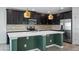 Modern kitchen showcasing stainless steel appliances and a large island with seating at 118 Green Branch Blvd, Groveland, FL 34736