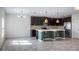 Open-concept kitchen with stainless steel appliances, mosaic tile backsplash, and ample counter space at 118 Green Branch Blvd, Groveland, FL 34736