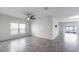 Bright living space featuring tile flooring, large windows, recessed lighting and sliding glass door to the patio at 118 Green Branch Blvd, Groveland, FL 34736