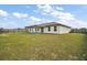 Home's expansive backyard with a charming patio and a well-maintained lawn at 12370 Se 100Th Ct, Belleview, FL 34420