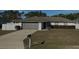 Charming single-story home with a well-maintained lawn and attached two-car garage at 12370 Se 100Th Ct, Belleview, FL 34420