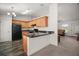 Modern kitchen with granite countertops, wood cabinets, and stainless steel appliances, open to the dining area at 12370 Se 100Th Ct, Belleview, FL 34420