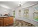 Bright eat-in kitchen area featuring sliding glass doors and modern lighting fixtures at 12370 Se 100Th Ct, Belleview, FL 34420