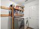Laundry room featuring modern washer and dryer with utility shelving and storage at 12370 Se 100Th Ct, Belleview, FL 34420