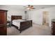 Cozy bedroom with neutral carpet, large bed, and an en-suite bathroom with shower at 12370 Se 100Th Ct, Belleview, FL 34420