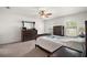 Comfortable main bedroom featuring neutral carpeting, large bed, and bright windows at 12370 Se 100Th Ct, Belleview, FL 34420