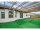 Covered patio with artificial grass, offering an inviting outdoor living space at 12370 Se 100Th Ct, Belleview, FL 34420