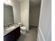 Bright bathroom with granite countertop vanity, toilet, and shower-tub combo at 12807 Sugar Ct, Grand Island, FL 32735