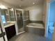 Bathroom featuring a soaking tub and separate shower at 12807 Sugar Ct, Grand Island, FL 32735