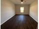 Bright bedroom with dark wood-look flooring and a ceiling fan at 12807 Sugar Ct, Grand Island, FL 32735