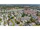 Expansive aerial shot of a meticulously planned community featuring sidewalks, green spaces, and beautiful lake views at 1310 Leone Ln, The Villages, FL 32159