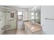 Bathroom featuring a glass enclosed shower, neutral tile and a vanity at 1310 Leone Ln, The Villages, FL 32159
