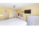 Comfortable bedroom with ceiling fan, television and dresser at 1310 Leone Ln, The Villages, FL 32159