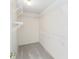 Bright walk-in closet featuring white walls, gray carpet and useful wire shelving system at 1310 Leone Ln, The Villages, FL 32159