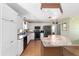 Bright open kitchen featuring white cabinets and stainless steel appliances at 1310 Leone Ln, The Villages, FL 32159