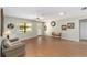 Bright living room featuring beautiful wood floors, large windows, and comfortable seating at 1310 Leone Ln, The Villages, FL 32159