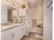 Bright bathroom featuring dual sinks, white cabinetry, granite countertops, shower, and modern fixtures, clean updated space at 13662 Se 55Th Ave, Summerfield, FL 34491