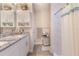 Bright bathroom featuring white cabinetry, granite countertops, shower, and modern fixtures, offering a clean and updated space at 13662 Se 55Th Ave, Summerfield, FL 34491