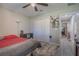 Bedroom featuring wood-look floors, modern lighting, and ample closet space offering a calm and uncluttered space at 13662 Se 55Th Ave, Summerfield, FL 34491