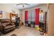 This bedroom features a workstation, fan, wood-look flooring, and a relaxing recliner at 13662 Se 55Th Ave, Summerfield, FL 34491