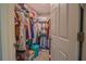 Walk-in closet providing ample storage space with shelving, hanging rods, and organization for clothing and accessories at 13662 Se 55Th Ave, Summerfield, FL 34491