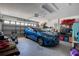 Spacious garage with overhead lighting, storage shelves, and ample space for parking a car at 13662 Se 55Th Ave, Summerfield, FL 34491