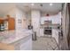Well-lit kitchen with stainless steel appliances, granite countertops, and white cabinetry at 13662 Se 55Th Ave, Summerfield, FL 34491