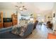 Spacious living room with modern flooring, ceiling fan, and open layout leading to the kitchen at 13662 Se 55Th Ave, Summerfield, FL 34491