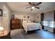 Cozy bedroom featuring a comfortable queen bed, modern flooring, and soft natural lighting at 13662 Se 55Th Ave, Summerfield, FL 34491