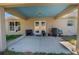Covered patio includes a blue ceiling, concrete flooring, and access to the backyard at 13662 Se 55Th Ave, Summerfield, FL 34491