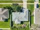 Aerial view showcasing a well-maintained home with a large, fenced backyard and a pristine gray roof at 1407 Island Cove Dr, Deland, FL 32724