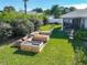 Backyard with an enclosed patio, garden beds, lawn, and peripheral landscaping at 1407 Island Cove Dr, Deland, FL 32724