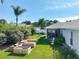 Spacious backyard featuring a patio, garden beds, lawn, and perimeter trees at 1407 Island Cove Dr, Deland, FL 32724