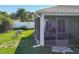 A screened in patio with furniture, an outdoor table with chairs, and white vinyl fencing at 1407 Island Cove Dr, Deland, FL 32724