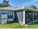 A screened in patio with furniture, a storage cabinet, and a green lawn at 1407 Island Cove Dr, Deland, FL 32724