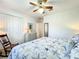 Cozy bedroom with a ceiling fan, a rocking chair, and neutral colors at 1407 Island Cove Dr, Deland, FL 32724