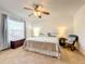 Bright bedroom with a ceiling fan, rocking chair, and large window at 1407 Island Cove Dr, Deland, FL 32724
