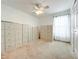 Minimalist bedroom with rows of file cabinets, a ceiling fan, and a sheer window curtain at 1407 Island Cove Dr, Deland, FL 32724