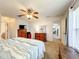Spacious bedroom with classic wooden furniture, a ceiling fan, and neutral tones at 1407 Island Cove Dr, Deland, FL 32724