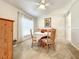 Bright dining room featuring a round table, four chairs, and a window dressed with white curtains at 1407 Island Cove Dr, Deland, FL 32724
