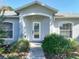 Inviting entryway featuring a decorative glass door and manicured landscaping at 1407 Island Cove Dr, Deland, FL 32724