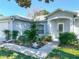 Close-up showcasing the home's facade with decorative glass door, fresh landscaping, and concrete walkway at 1407 Island Cove Dr, Deland, FL 32724