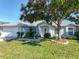 Charming single-story home features a well-manicured lawn, mature tree and a bright exterior at 1407 Island Cove Dr, Deland, FL 32724