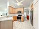 Bright kitchen with stainless steel appliances, tile flooring and wood cabinets at 1407 Island Cove Dr, Deland, FL 32724