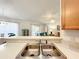 Bright kitchen featuring stainless steel sink, bar top, and an open view into the living room at 1407 Island Cove Dr, Deland, FL 32724