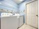 A laundry room features a modern washer and dryer with plenty of storage space at 1407 Island Cove Dr, Deland, FL 32724