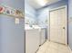 A laundry room features a modern washer and dryer with plenty of storage space at 1407 Island Cove Dr, Deland, FL 32724